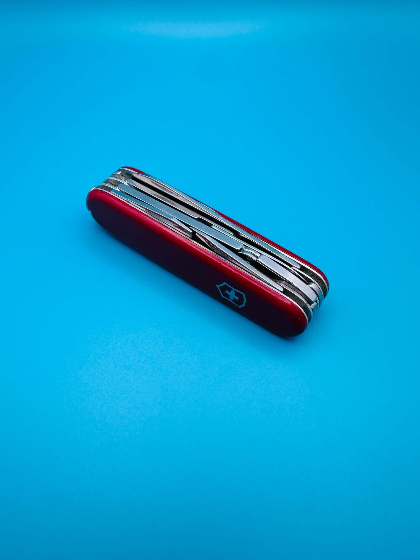 Closed Victorinox Deluxe Tinker Swiss Army Knife with red scales