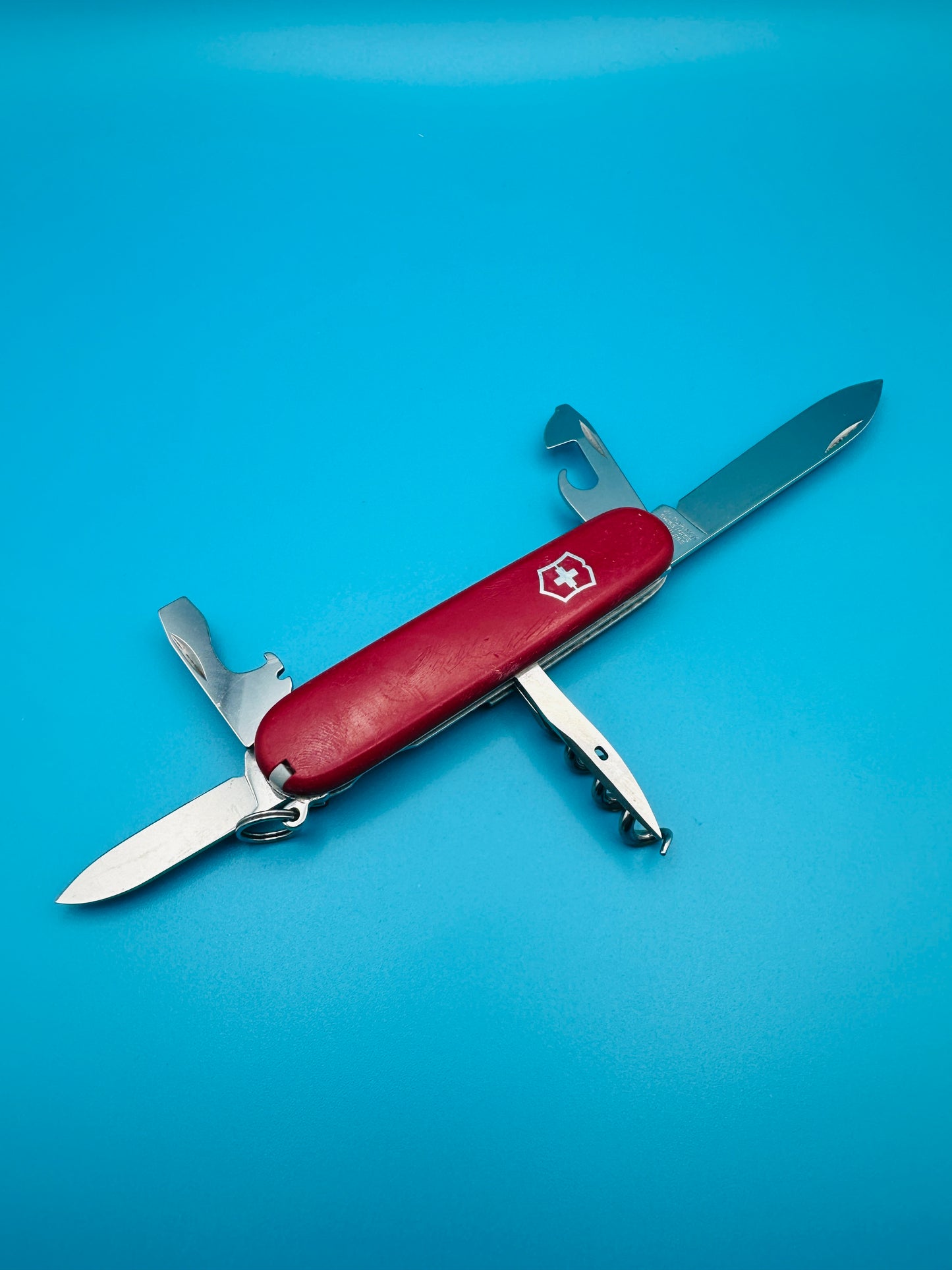 Top view of red Victorinox Spartan with small blade and screwdriver unfolded