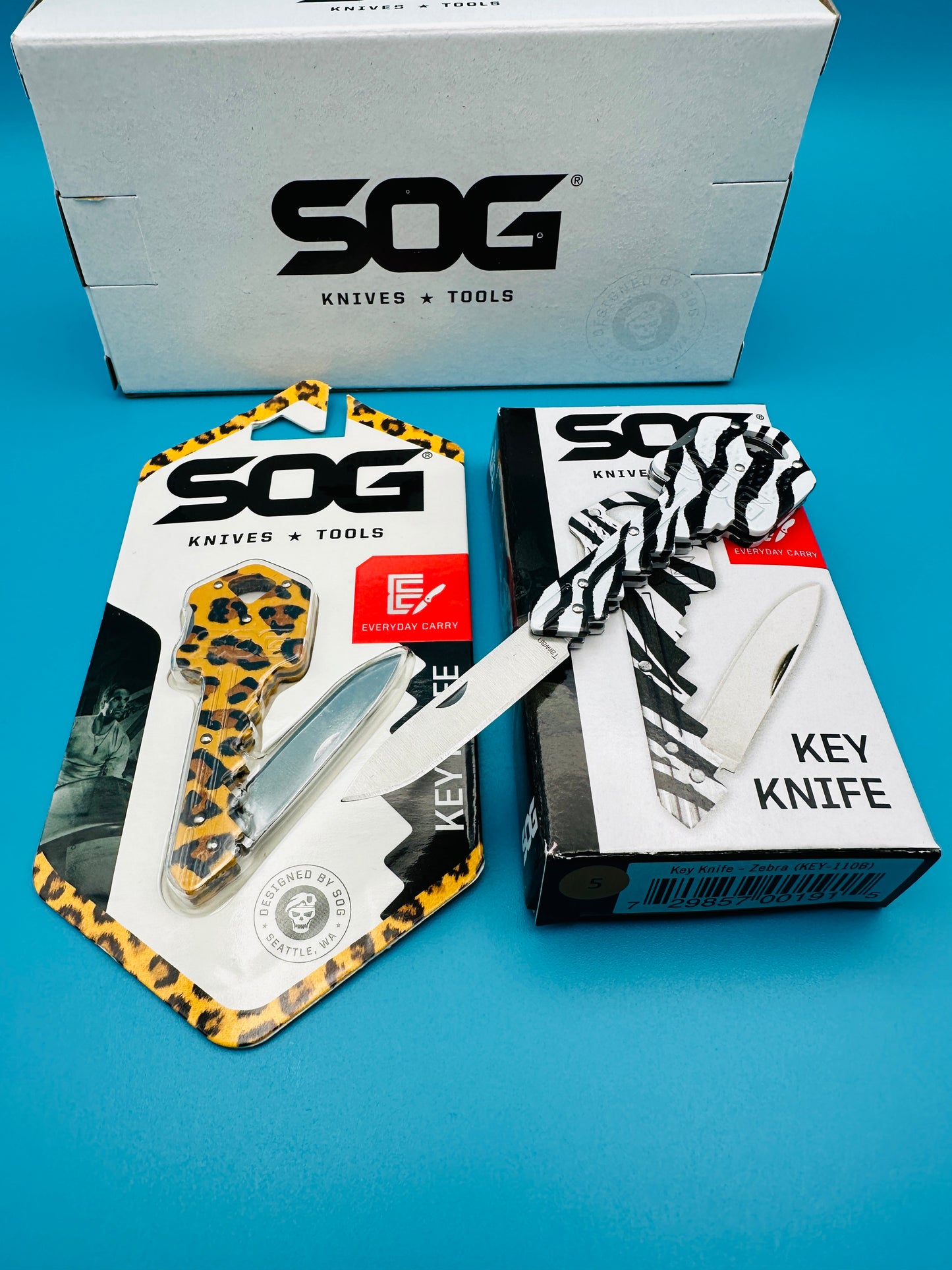 “SOG Jungle Key Lockback bundle showing cheetah and zebra knives in packaging with boxes”