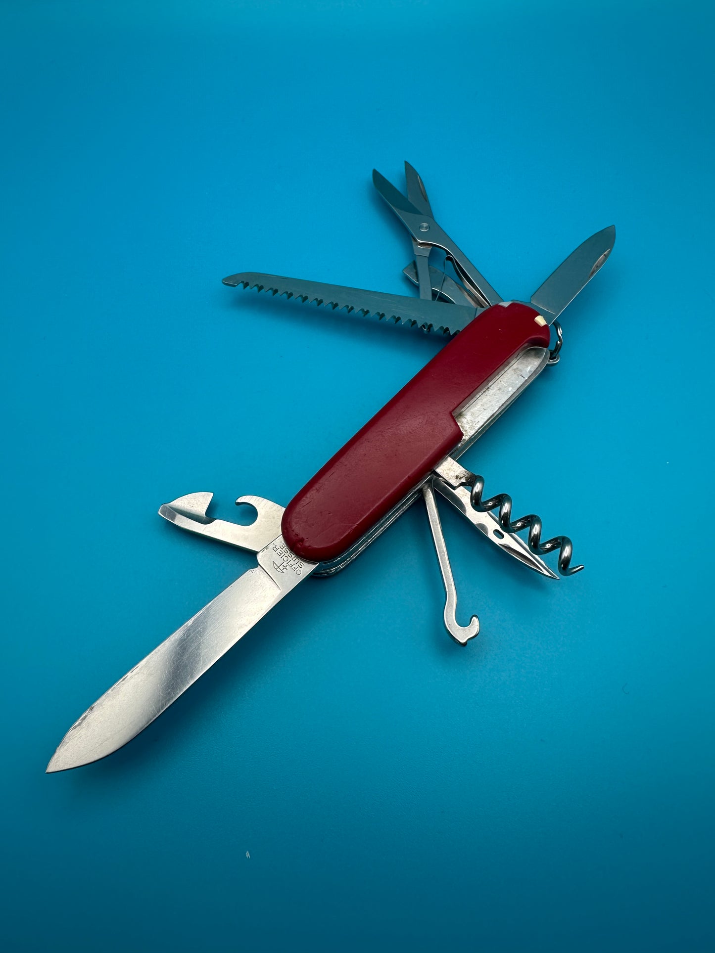 Victorinox Huntsman with partially extended scissors, bottle opener, and small blade