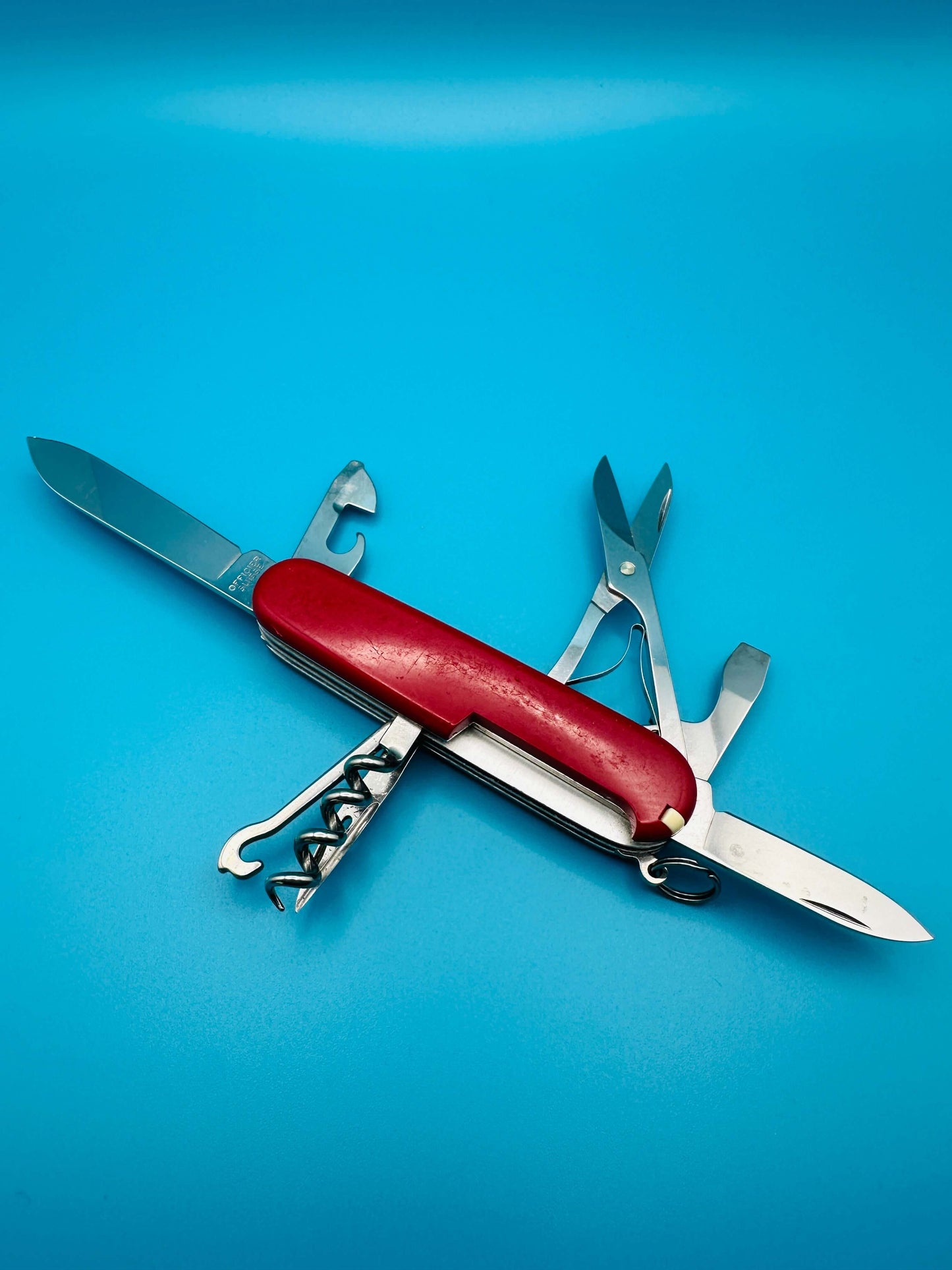 Top-down view of Victorinox Climber Swiss Army knife with extended hook, blade, and corkscrew