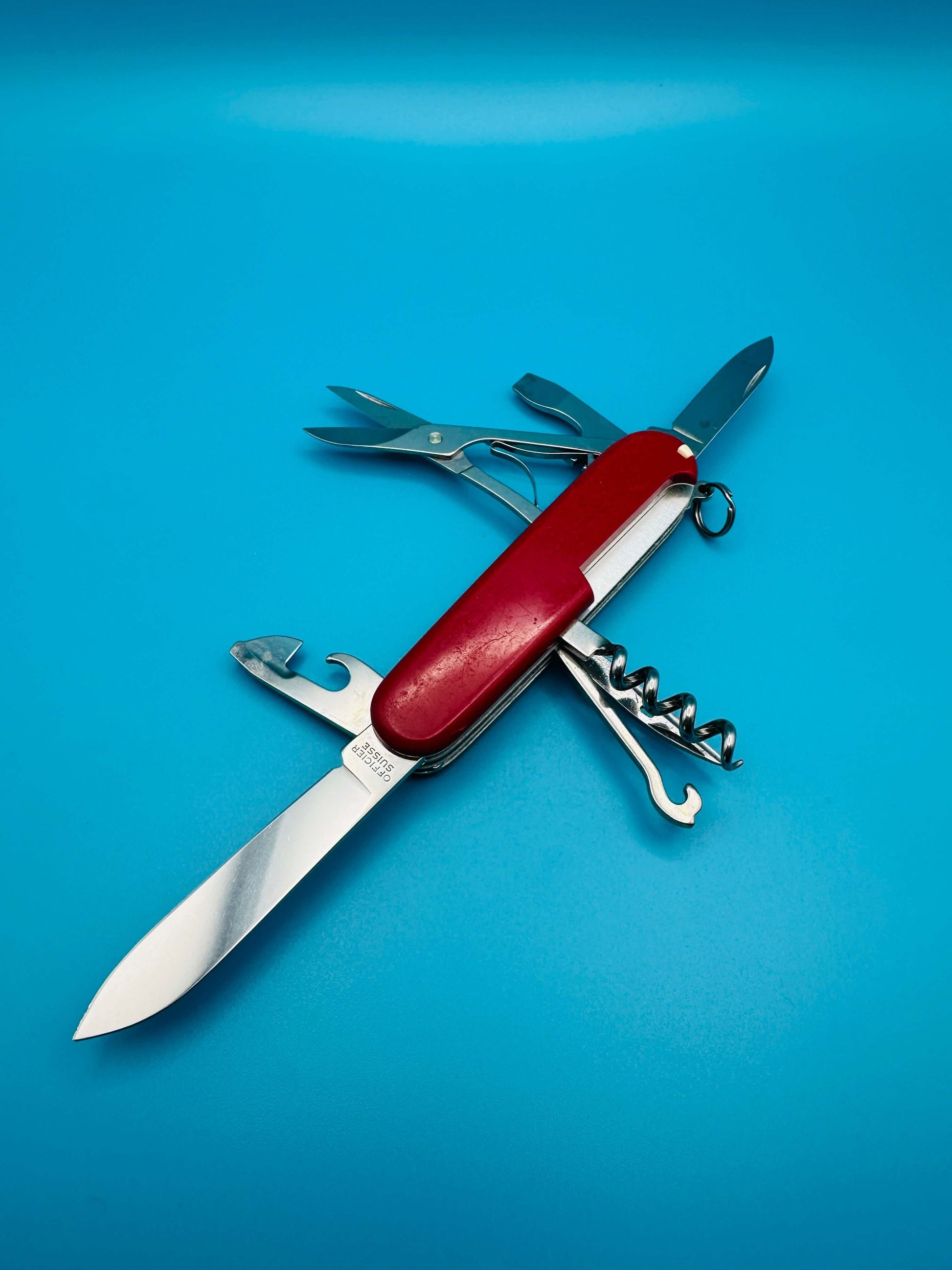 Compact Swiss Army knife Victorinox Climber showing open can opener, bottle opener, and scissors

